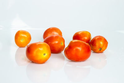 Close-up of tomatoes over white background