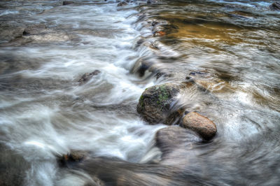 High angle view of water flowing through rocks