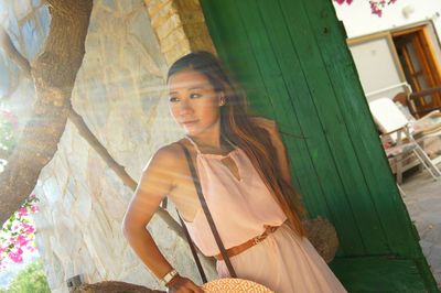 Beautiful woman standing by door