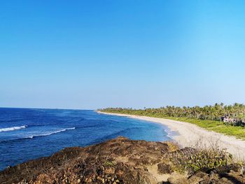 Scenic view of sea against clear blue sky