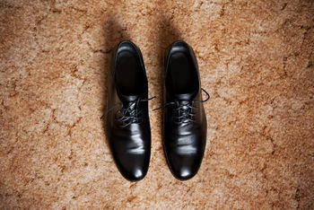 Directly above shot of formal shoes on field