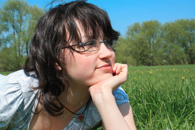 Close-up of young woman in grass