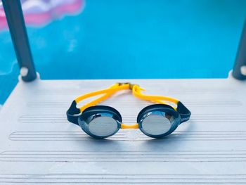 High angle view of sunglasses on table at swimming pool