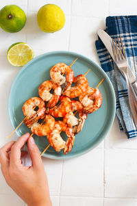 High angle view of person holding food on table