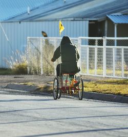 Rear view of man on tricycle