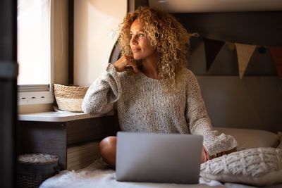 Young woman using mobile phone at home