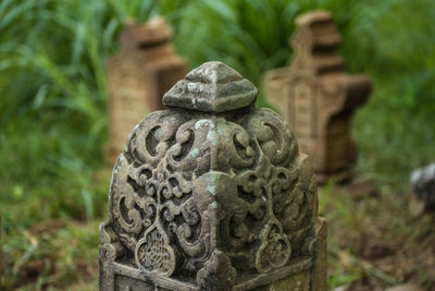 Close-up of statue against stone wall