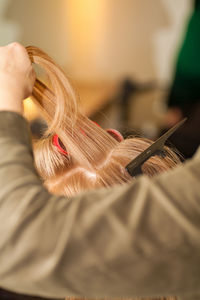 Close-up of woman holding hair home