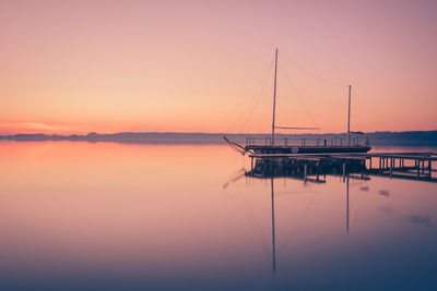 Sailboat in sea at sunset