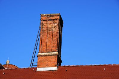 Low angle view of tower against clear blue sky