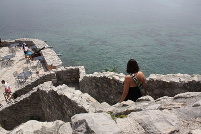 Woman sitting on rock