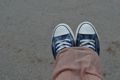 Low section of woman wearing canvas shoe