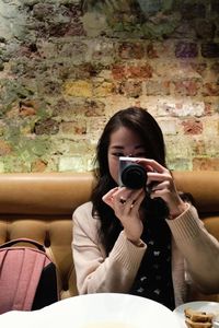 Portrait of a woman holding ice cream in restaurant