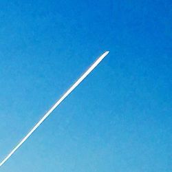 Low angle view of airplane against clear sky