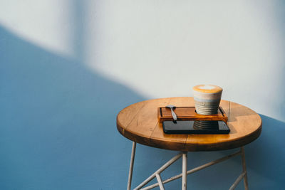 Coffee on table against wall