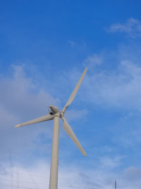 Low angle view of windmill against sky