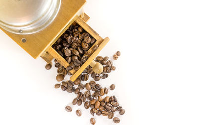 High angle view of coffee beans against white background