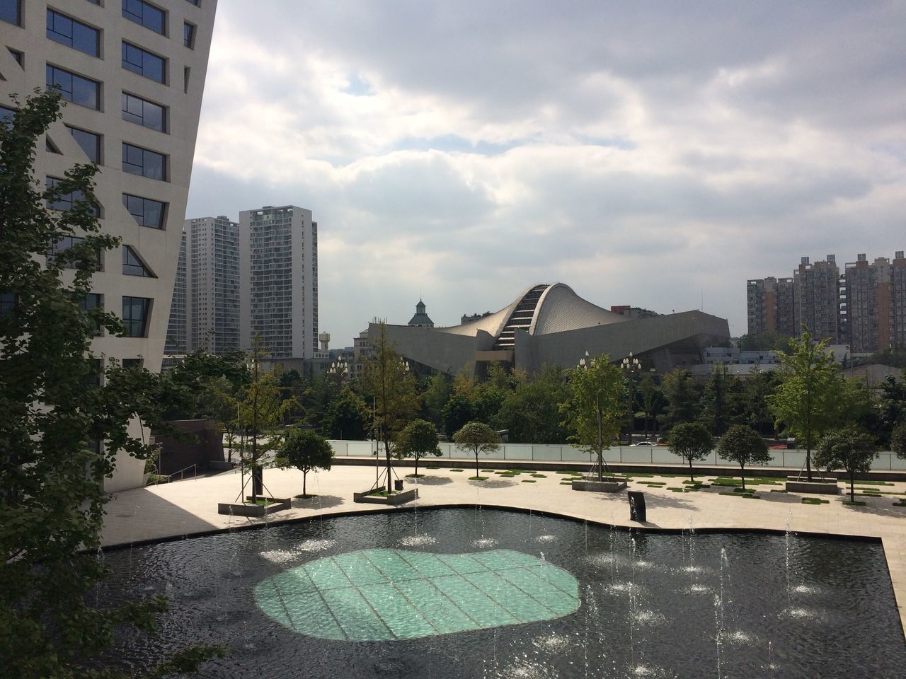 building exterior, architecture, built structure, city, tree, sky, cloud - sky, men, city life, cityscape, lifestyles, leisure activity, skyscraper, incidental people, person, cloud, building, modern, park - man made space