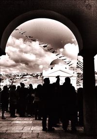 Silhouette people against cloudy sky