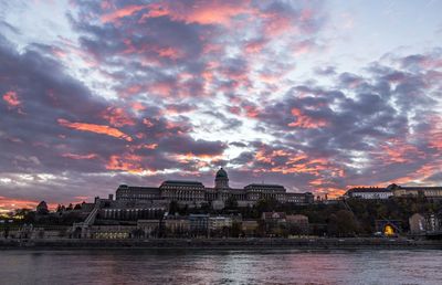 View of city at waterfront during sunset