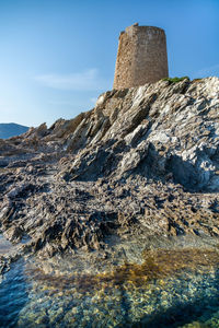 Low angle view of rock formation against sky