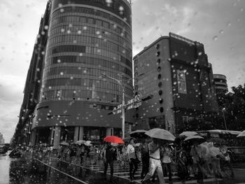 Men in city against sky