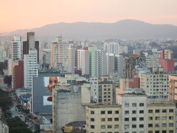 High angle view of buildings in city against sky during sunset