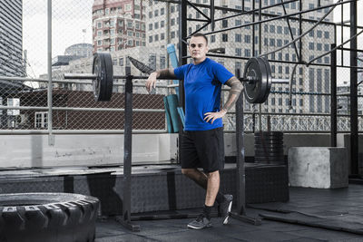 Man training at rooftop gym in bangkok