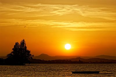 Scenic view of sea against romantic sky at sunset