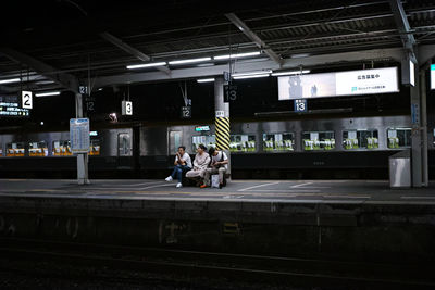 People waiting at railroad station platform