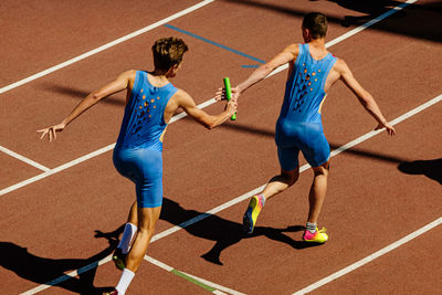 Male relay race running for track and field competition