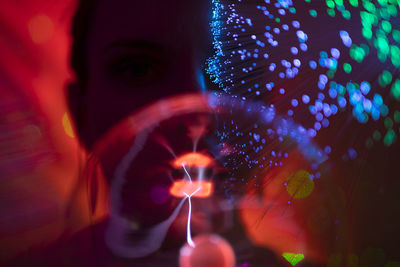 Close-up portrait of man with illuminated lights