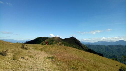 Scenic view of landscape against blue sky