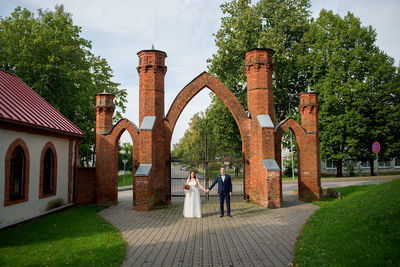 Bride and groom standing at park