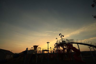 Silhouette people playing against sky during sunset