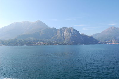 Scenic view of sea and mountains against sky