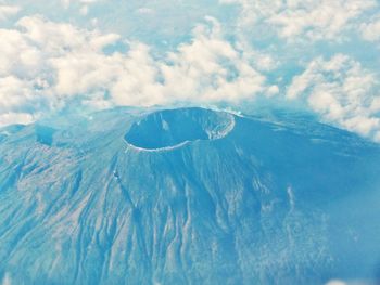 Scenic view of mountains against cloudy sky