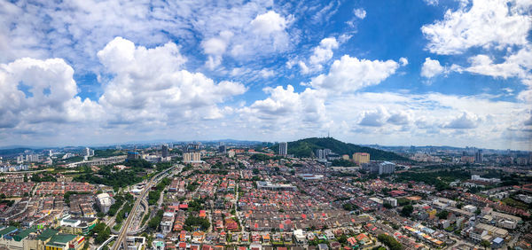 High angle view of city against cloudy sky