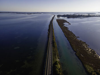 Aerial view of cars driving on a  road crossing the lagoon in gorizia, friuli venezia giulia, italy.