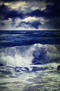 Scenic view of sea against cloudy sky