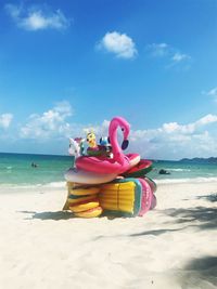 Inflatable rings at beach on sunny day