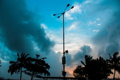 Low angle view of silhouette street light against sky