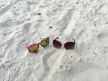 High angle view of sunglasses on beach