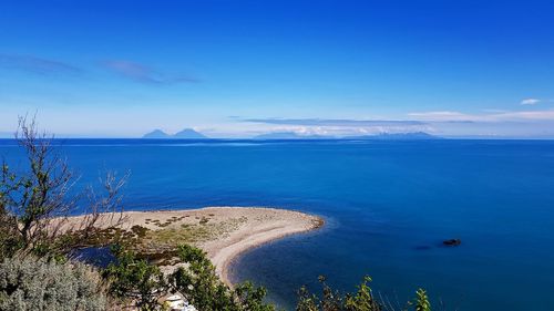 Scenic view of sea against blue sky