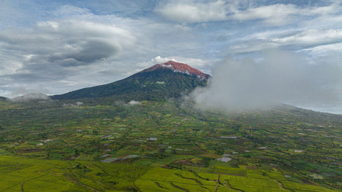 Aerial drone of farmland and tea plantations next to mount kerinci. sumatra, indonesia.