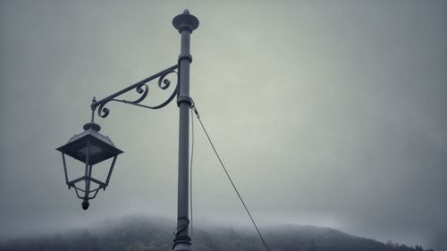 Low angle view of street light against sky