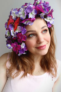 Close-up of thoughtful young woman wearing flowers