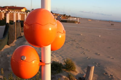 Close-up of orange ball on beach