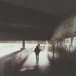 Woman walking in tunnel