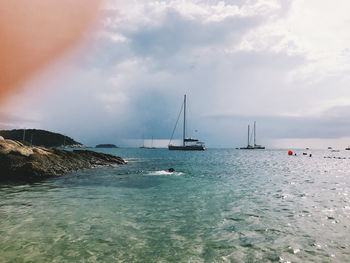 Sailboat sailing on sea against sky